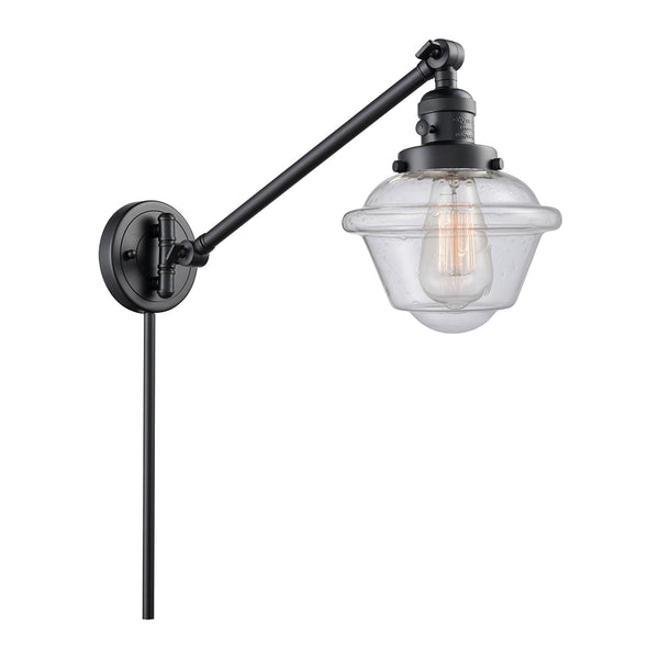 Oxford Swing Arm shown in the Matte Black finish with a Seedy shade