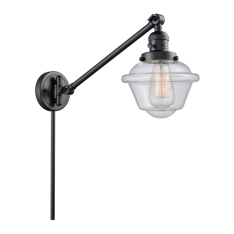 Oxford Swing Arm shown in the Matte Black finish with a Seedy shade