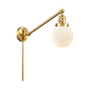 Beacon Swing Arm shown in the Satin Gold finish with a Matte White shade