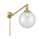 Beacon Swing Arm shown in the Satin Gold finish with a Clear shade