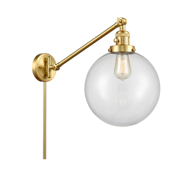 Beacon Swing Arm shown in the Satin Gold finish with a Clear shade