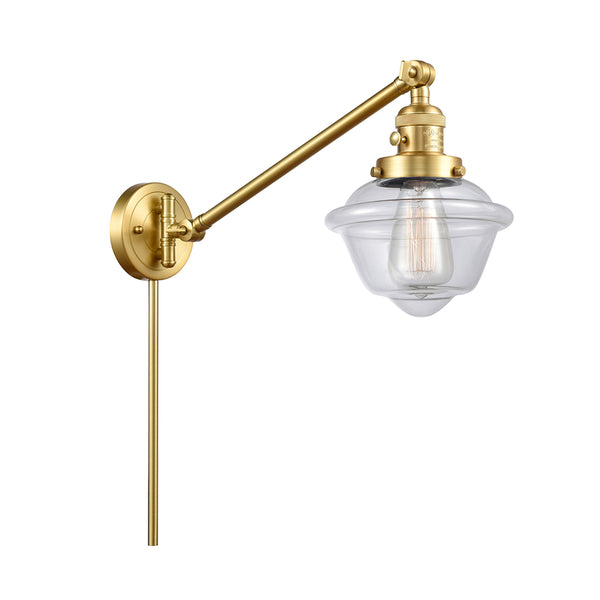 Oxford Swing Arm shown in the Satin Gold finish with a Clear shade