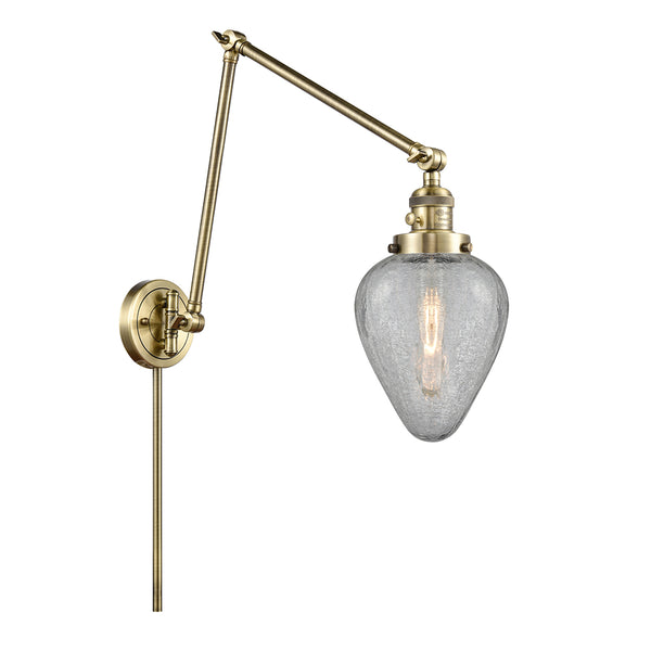 Geneseo Swing Arm shown in the Antique Brass finish with a Clear Crackled shade