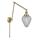 Geneseo Swing Arm shown in the Antique Brass finish with a Clear Crackled shade