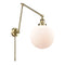 Beacon Swing Arm shown in the Antique Brass finish with a Matte White shade