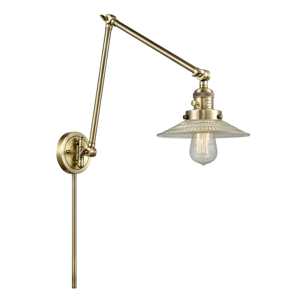 Halophane Swing Arm shown in the Antique Brass finish with a Clear Halophane shade