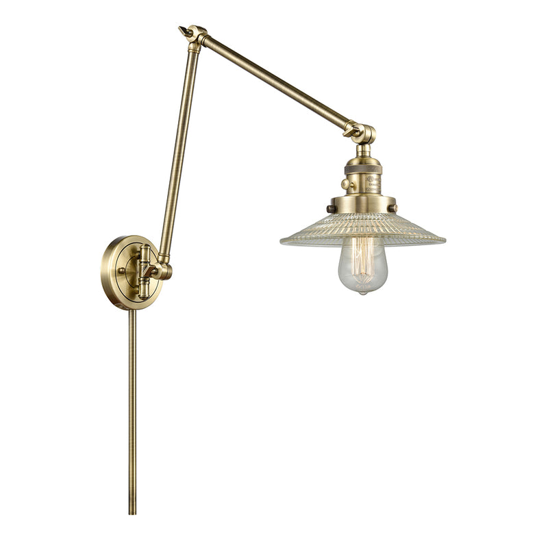 Halophane Swing Arm shown in the Antique Brass finish with a Clear Halophane shade