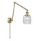 Colton Swing Arm shown in the Antique Brass finish with a Clear Halophane shade