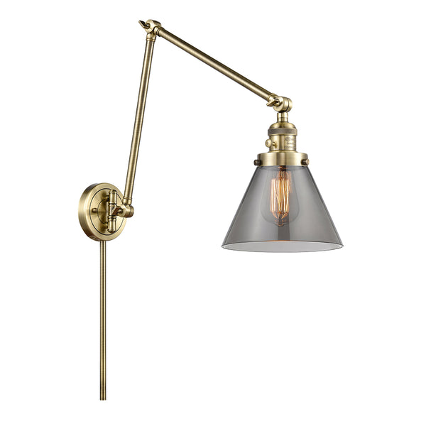 Cone Swing Arm shown in the Antique Brass finish with a Plated Smoke shade