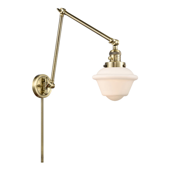 Oxford Swing Arm shown in the Antique Brass finish with a Matte White shade