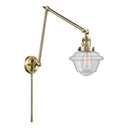 Oxford Swing Arm shown in the Antique Brass finish with a Seedy shade