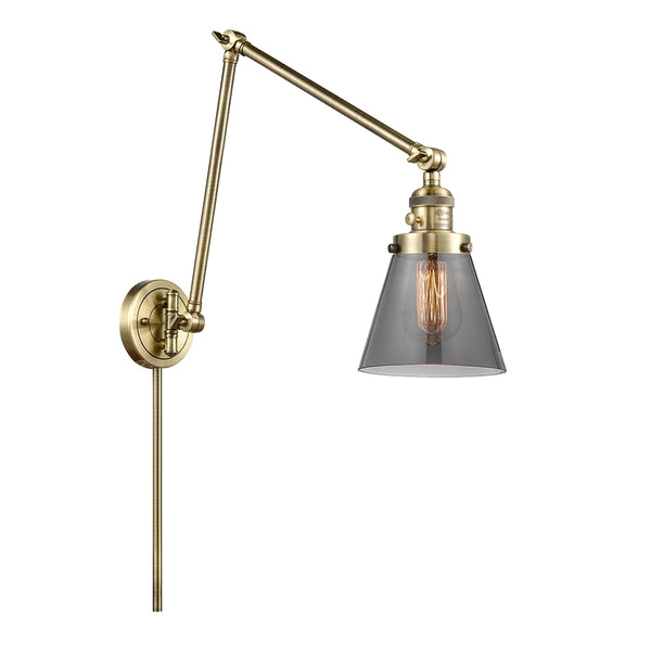 Cone Swing Arm shown in the Antique Brass finish with a Plated Smoke shade