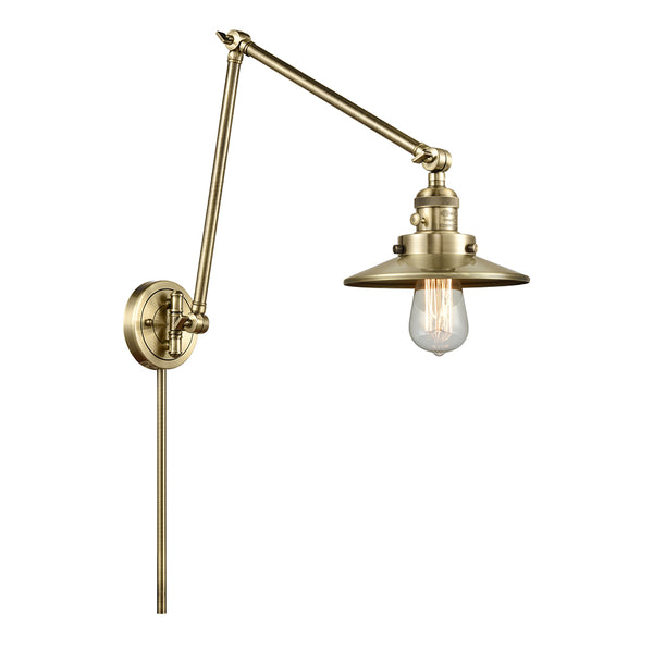 Railroad Swing Arm shown in the Antique Brass finish with a Antique Brass shade