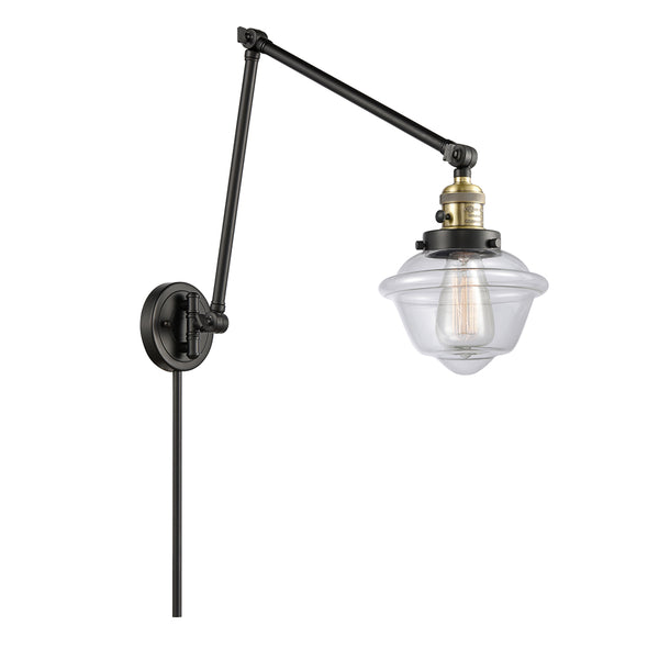 Oxford Swing Arm shown in the Black Antique Brass finish with a Clear shade