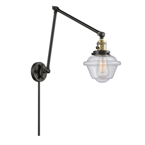 Oxford Swing Arm shown in the Black Antique Brass finish with a Seedy shade