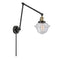 Oxford Swing Arm shown in the Black Antique Brass finish with a Seedy shade