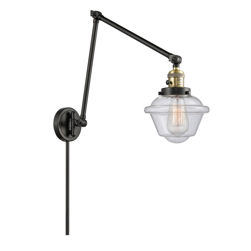 Oxford Swing Arm shown in the Black Antique Brass finish with a Seedy shade