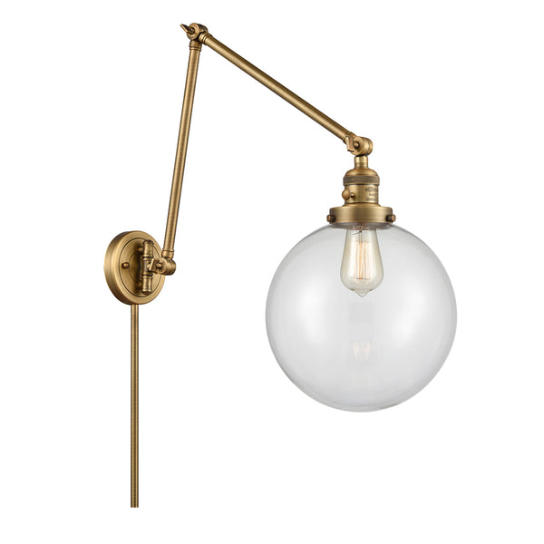 Beacon Swing Arm shown in the Brushed Brass finish with a Clear shade