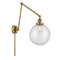 Beacon Swing Arm shown in the Brushed Brass finish with a Clear shade