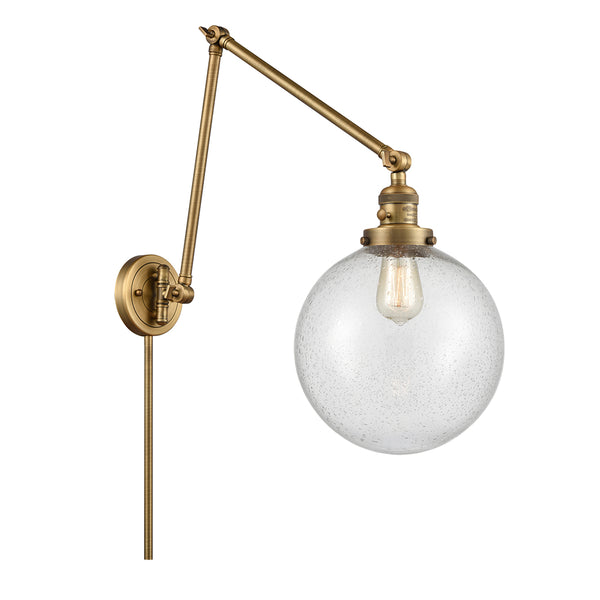 Beacon Swing Arm shown in the Brushed Brass finish with a Seedy shade
