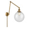 Beacon Swing Arm shown in the Brushed Brass finish with a Seedy shade