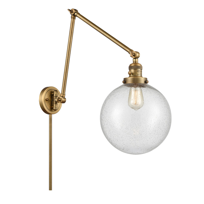 Beacon Swing Arm shown in the Brushed Brass finish with a Seedy shade
