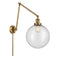 Beacon Swing Arm shown in the Brushed Brass finish with a Seedy shade