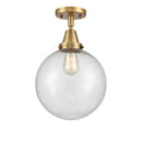 Beacon Flush Mount shown in the Brushed Brass finish with a Seedy shade