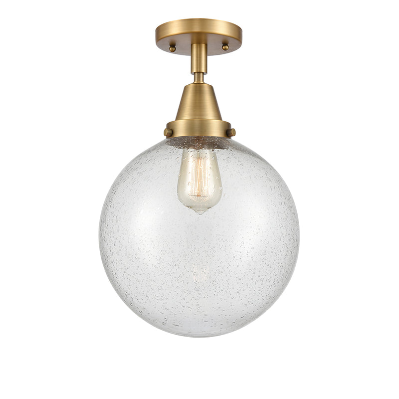 Beacon Flush Mount shown in the Brushed Brass finish with a Seedy shade