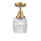 Colton Flush Mount shown in the Brushed Brass finish with a Clear Halophane shade