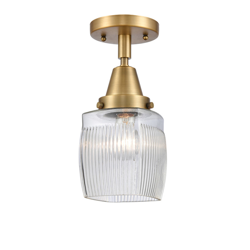 Colton Flush Mount shown in the Brushed Brass finish with a Clear Halophane shade