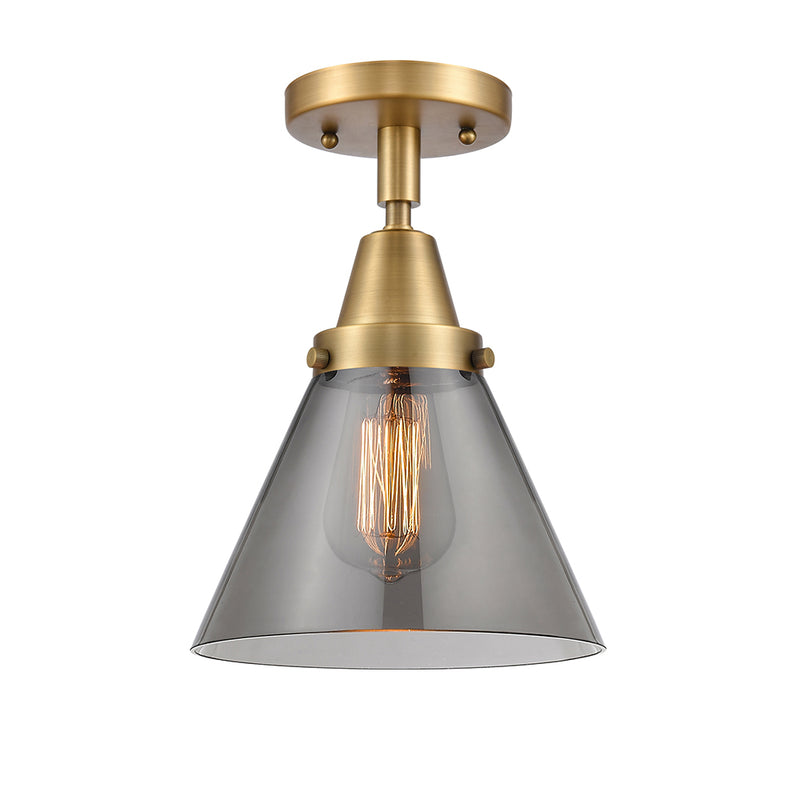 Cone Flush Mount shown in the Brushed Brass finish with a Plated Smoke shade