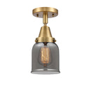 Bell Flush Mount shown in the Brushed Brass finish with a Plated Smoke shade