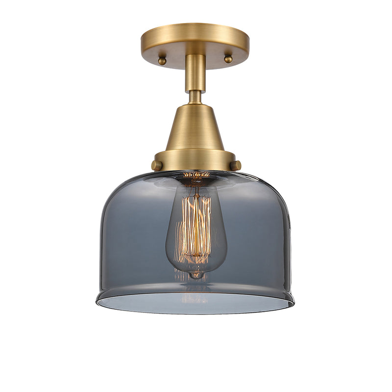 Bell Flush Mount shown in the Brushed Brass finish with a Plated Smoke shade