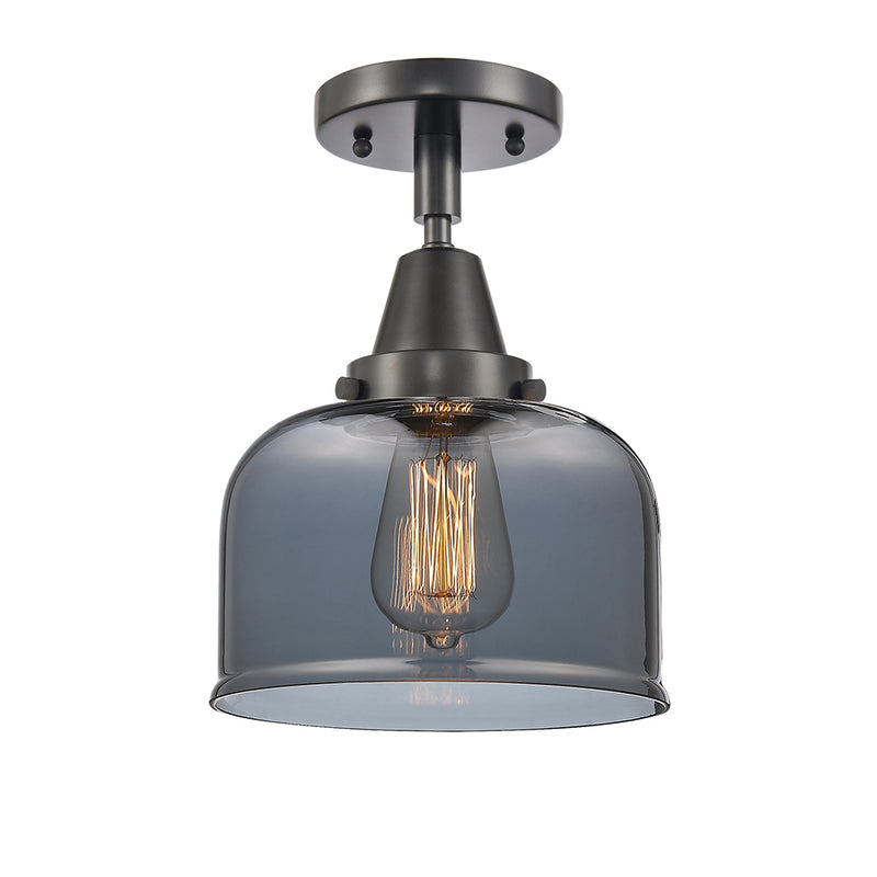 Bell Flush Mount shown in the Matte Black finish with a Plated Smoke shade