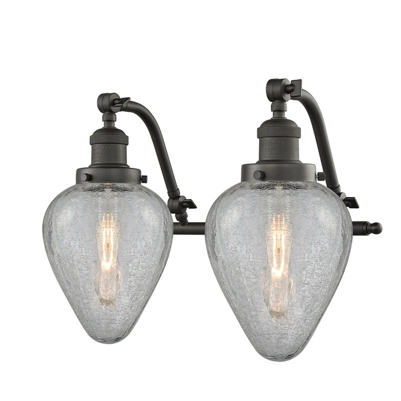 Geneseo Bath Vanity Light shown in the Oil Rubbed Bronze finish with a Clear Crackled shade