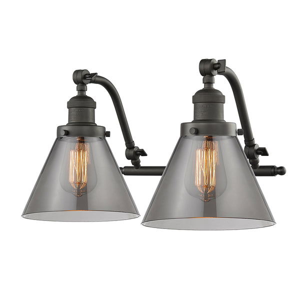 Cone Bath Vanity Light shown in the Oil Rubbed Bronze finish with a Plated Smoke shade
