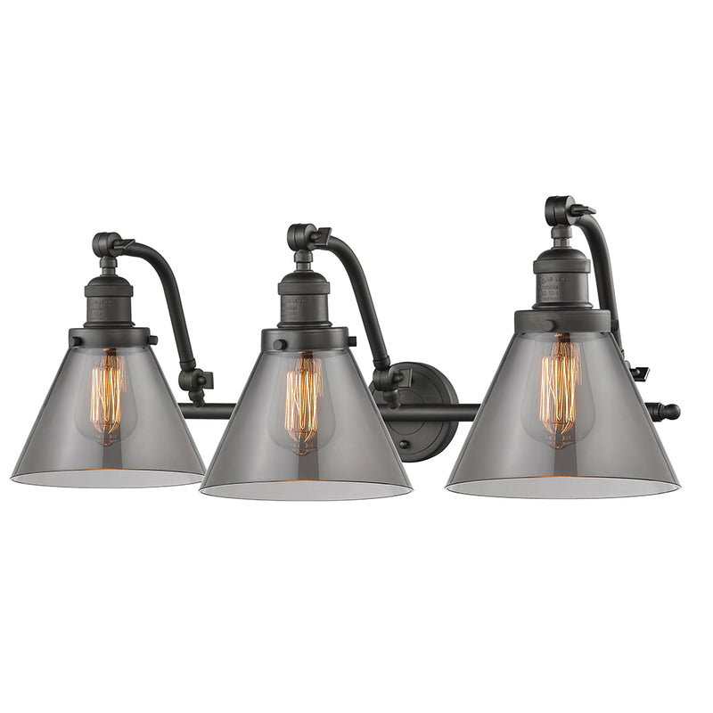 Cone Bath Vanity Light shown in the Oil Rubbed Bronze finish with a Plated Smoke shade