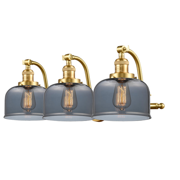 Bell Bath Vanity Light shown in the Satin Gold finish with a Plated Smoke shade