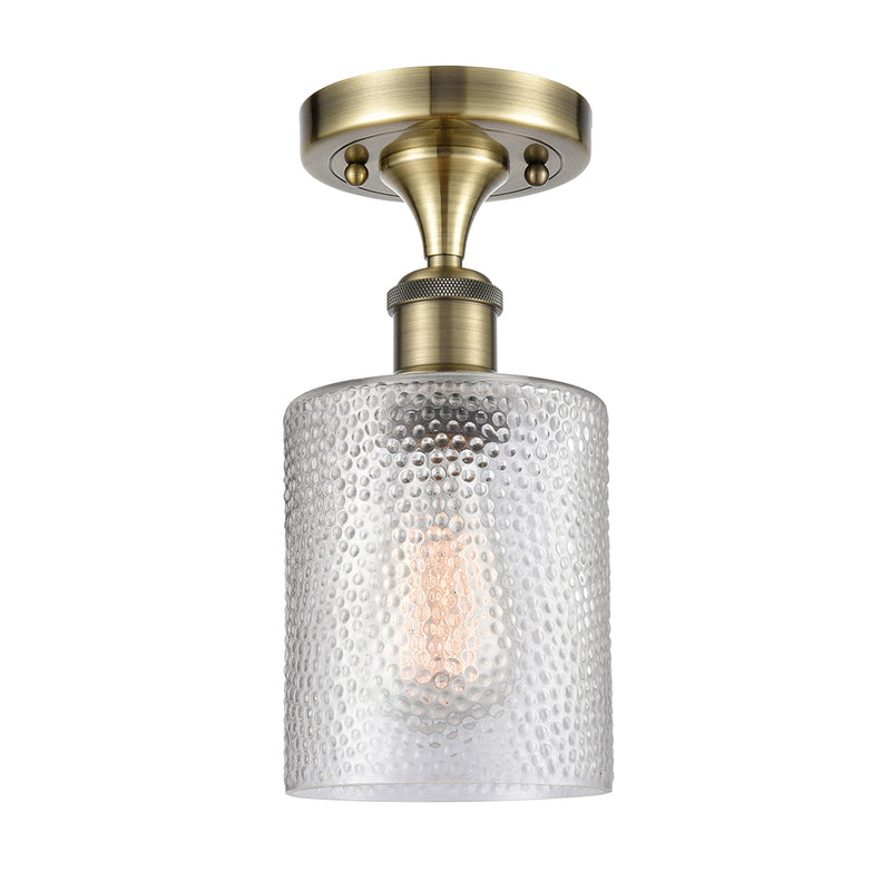 Cobbleskill Semi-Flush Mount shown in the Antique Brass finish with a Clear shade