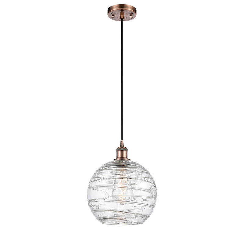 Deco Swirl Mini Pendant shown in the Antique Copper finish with a Clear shade