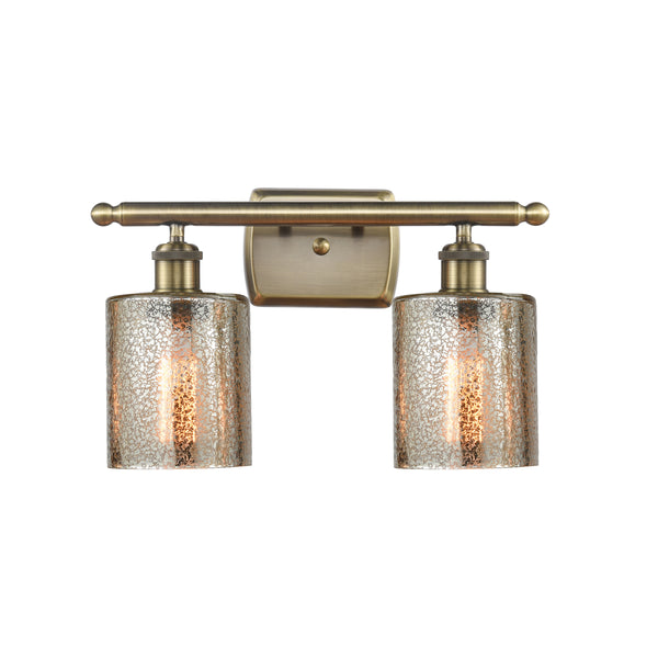 Cobbleskill Bath Vanity Light shown in the Antique Brass finish with a Mercury shade