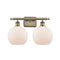 Athens Bath Vanity Light shown in the Antique Brass finish with a Matte White shade