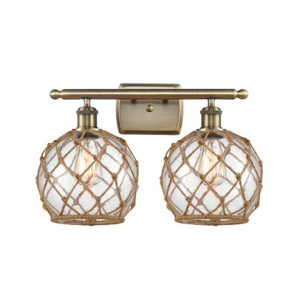Farmhouse Rope Bath Vanity Light shown in the Antique Brass finish with a Clear Glass with Brown Rope shade
