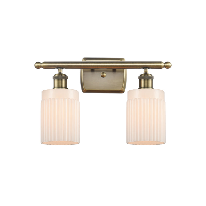 Hadley Bath Vanity Light shown in the Antique Brass finish with a Matte White shade