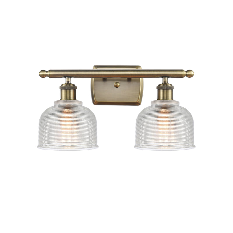 Dayton Bath Vanity Light shown in the Antique Brass finish with a Clear shade