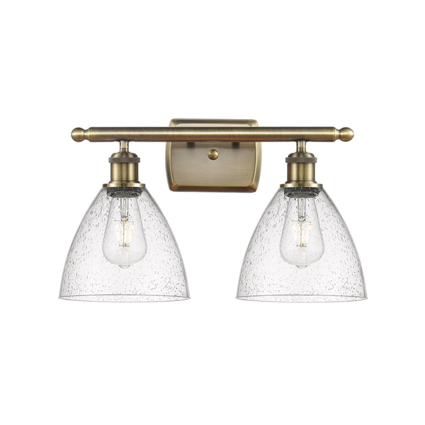 Ballston Dome Bath Vanity Light shown in the Antique Brass finish with a Seedy shade