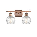 Deco Swirl Bath Vanity Light shown in the Antique Copper finish with a Clear shade