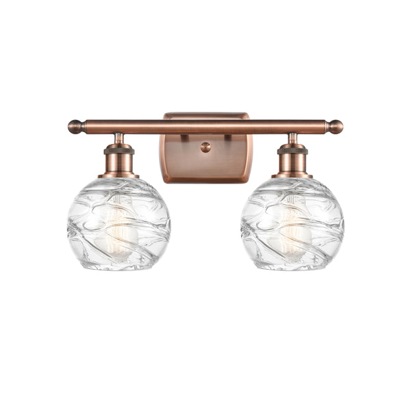 Deco Swirl Bath Vanity Light shown in the Antique Copper finish with a Clear shade