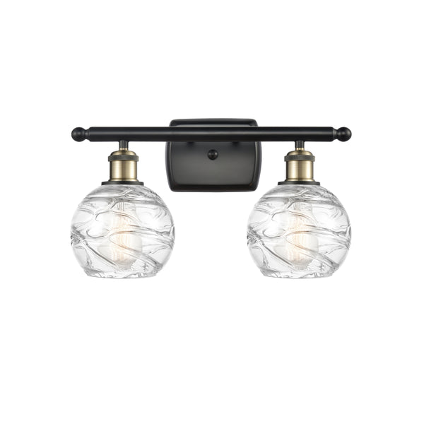 Deco Swirl Bath Vanity Light shown in the Black Antique Brass finish with a Clear shade